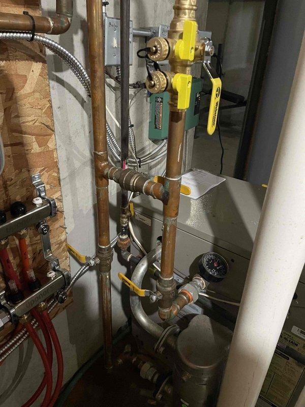 Successfully installed a mixing valve to regulate flow in the basement hydronic loop as part of required service work. Properly integrated the valve assembly into the existing copper distribution system on the mechanical room wall, ensuring appropriate pressure regulation between supply and return lines. System now functioning as designed with proper temperature control for the basement zone.