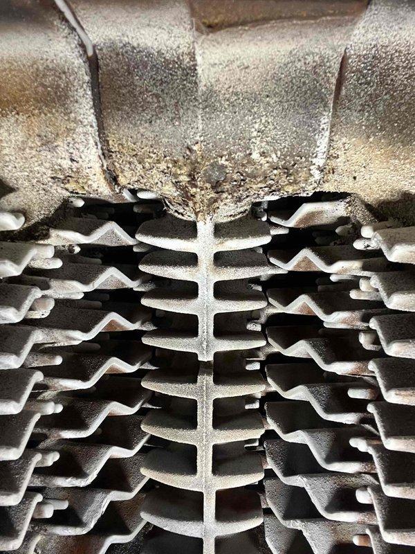 Completed scheduled annual preventative maintenance service on customer's boiler system. Inspected heat exchanger and cooling fins, noting significant dust accumulation and minor corrosion on metal surfaces. Cleaned accessible components to improve system efficiency.