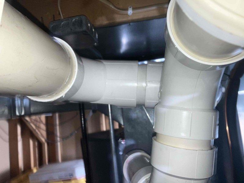 Diagnosed and replaced leaking exhaust pipe on furnace that was causing water accumulation around the unit. Installed new PVC piping with proper joints and connections to ensure proper condensate drainage and prevent future leaks.
