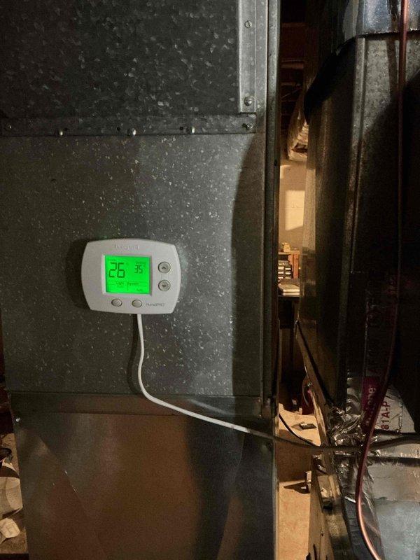 Responded to service call for IAQ system. Found humidifier with active corrosion causing water leak; water supply was shut off to prevent further damage. Located and repaired hole in humidifier line, restoring proper system function. Documented repair with photos of thermostat and HVAC unit.