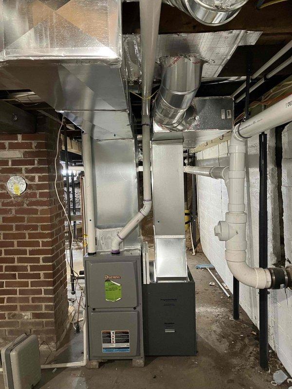 Partially installed return trunk line in basement mechanical room, requiring fabrication of custom fittings. Job remains incomplete with need to finish the return trunk line and connect two returns. Four 7-inch pivot tab collar style take-offs have been requested for the completion work.