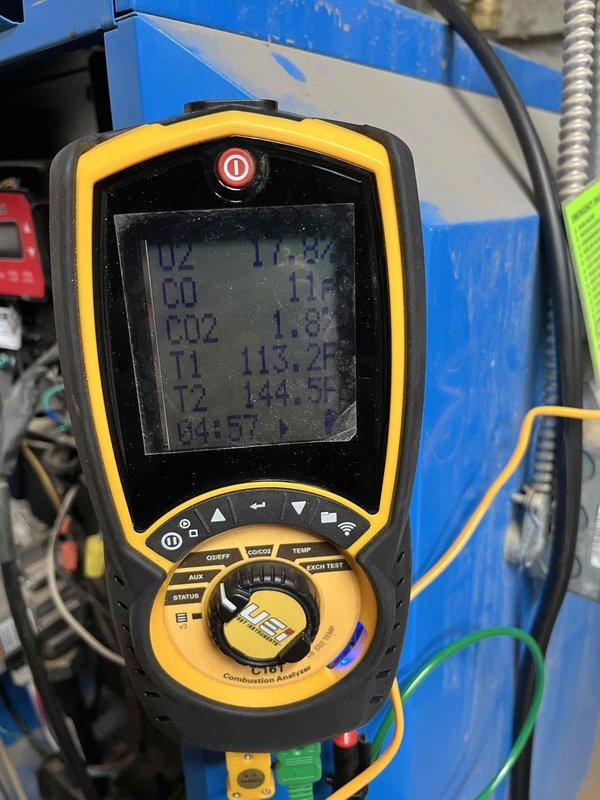 Responded to heating issue occurring since last annual inspection where boiler was not maintaining set temperature. Performed combustion analysis (readings: O2 11.2%, CO 11ppm, CO2 1.8%, temperatures T1 113.2°F/T2 144.9°F) and pressure testing (+30.70) to diagnose problem. Identified significant draft from adjacent crawl space affecting boiler operation; recommended customer have crawl space sealed to resolve the issue.