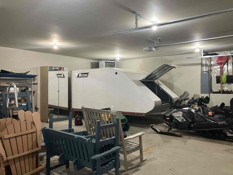 Diagnosed non-functioning Hot Dawg heater in detached garage. Unit approximately 7 years old with operational blower but ignition failure. Heater positioned above snowmobile trailer created access challenges. Customer concerned about protecting boat motor from freezing temperatures.