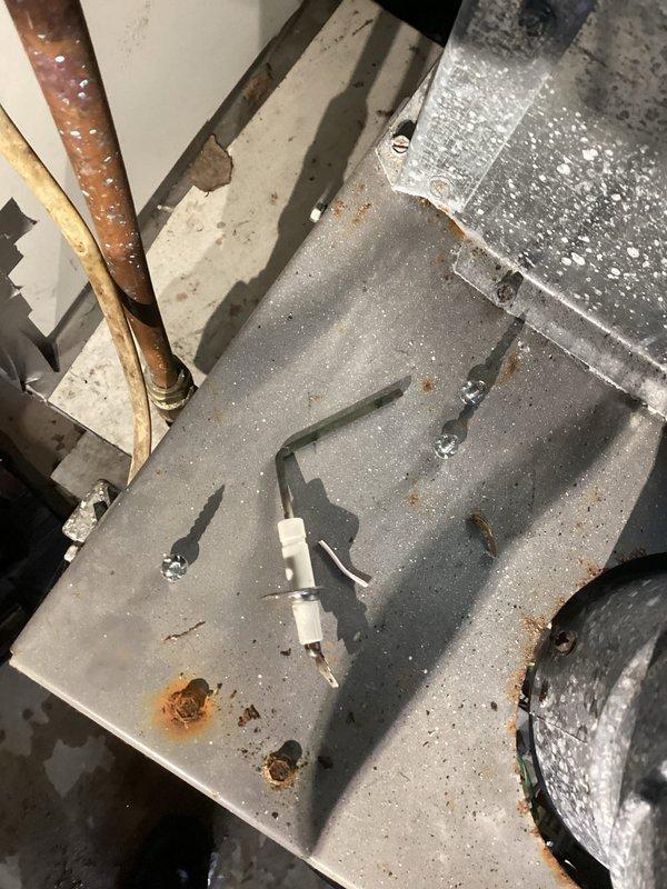 Performed follow-up diagnostic on 20-year-old furnace experiencing intermittent heating failure. Inspection revealed heavily corroded burners, compromised flame sensor, and inducer motor with audible bearing wear. Removed and inspected gas manifold assembly, found significant deterioration requiring replacement. Customer informed about repair options and availability of complete system replacement quote due to equipment age and condition.