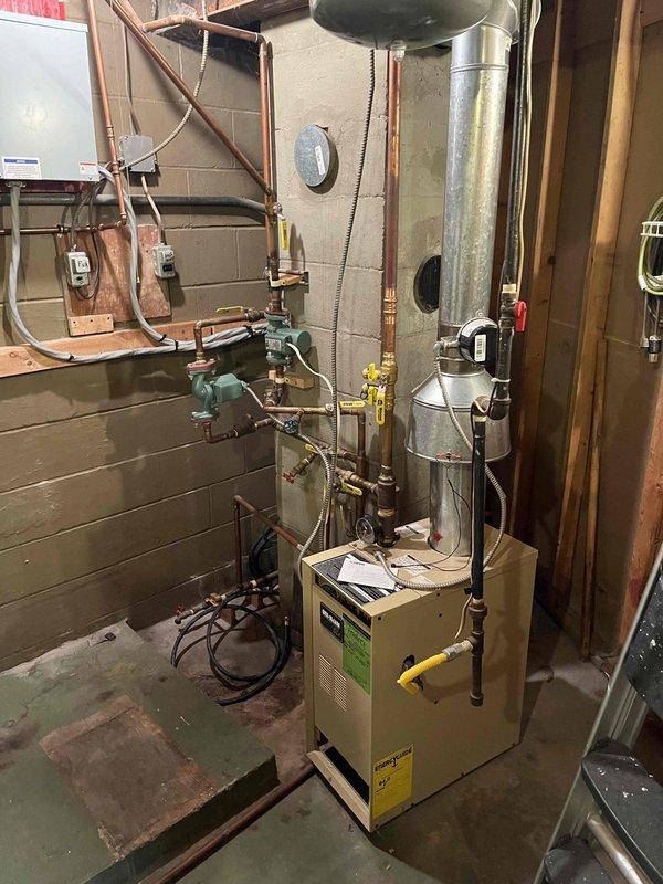 Returned to complete previously sold repair work as scheduled. Successfully replaced the control module, zone pump and pilot assembly on the heating system. Completed the job in the mechanical room where the existing furnace unit connects to a complex network of copper piping and circulation pumps mounted against concrete block walls.