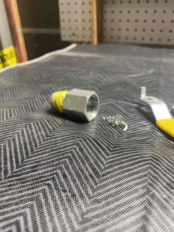 Responded to emergency gas leak detection near water heater installation. Identified failing ball valve between gas supply and water heater unit. Shut off gas supply for safety and replaced defective gas cock with new components including 1/2" gas line, properly sealed with teflon tape to ensure secure connection. System was tested for leaks after repair and confirmed safe for operation.