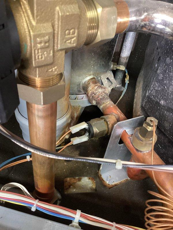 Responded to no-heat emergency at residential property with 10-year-old boiler system. Diagnostic inspection revealed faulty pressure sensor causing hot water interruption. Observed oxidation and corrosion on copper piping, with notable moisture accumulation within the mechanical enclosure. System repair requirements documented and customer advised of necessary replacement components.