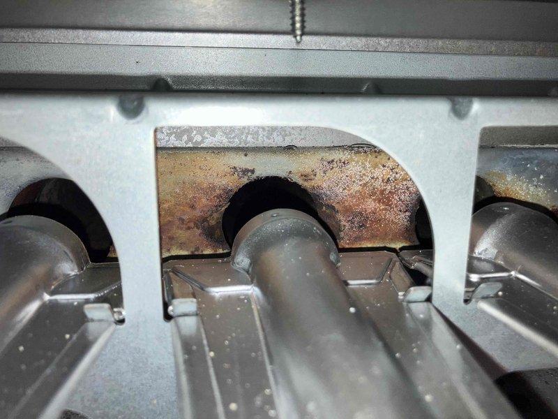 Responded to no heat complaint on 10+ year old furnace system. Diagnostic inspection revealed sooted heat exchanger with significant corrosion around ventilation components. Service performed included thorough cleaning of heat exchanger, replacement of compromised venting system, and installation of new inducer motor assembly to restore proper system operation.