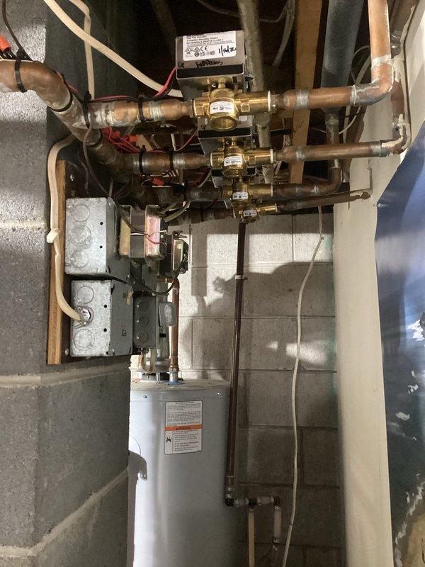 Responded to no heat complaint in a zoned hydronic heating system. Diagnosed air lock in the system and multiple leaking zone valves. Purged air from the system, replaced faulty zone valves, rebuilt water distribution components, and installed new drain valve on the 6-9 year old boiler to restore proper heating function to all zones.