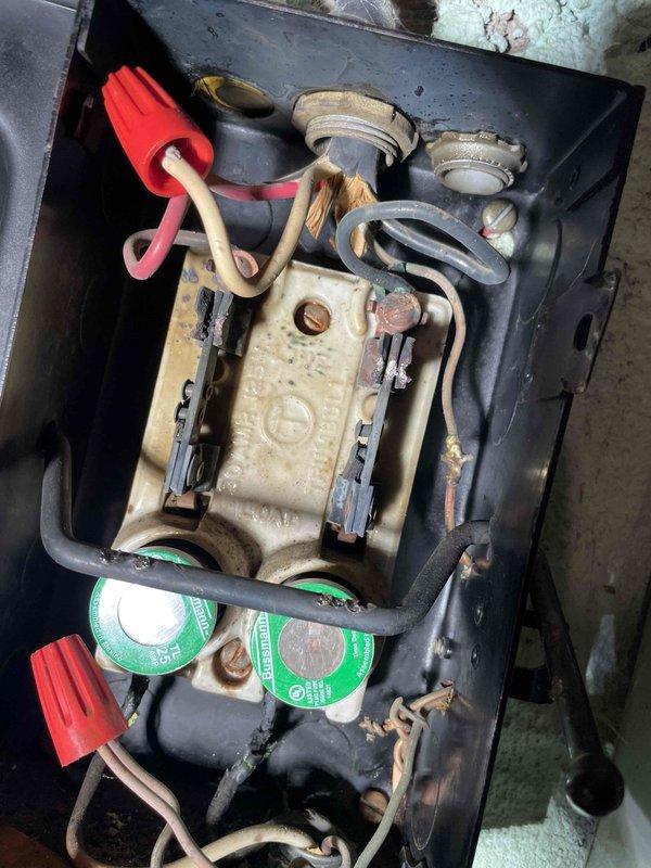 Responded to callback for no hot water on 9-month-old electric water heater. Diagnostic inspection revealed no incoming power to the water heater disconnect. Observed aging electrical components in junction box with visible discoloration and wear. Customer advised of electrical issue and recommended professional electrician for further diagnosis and repair.