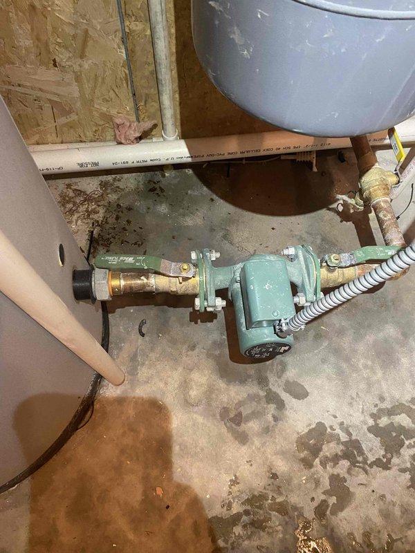 Responded to service call for an 11-year-old boiler with active leak. Diagnostic inspection revealed leaking gasket at pipe connection. Tightened connection nut to resolve the leak while maintaining system operation. Circulation pump and associated plumbing components inspected and verified to be functioning properly after repair.