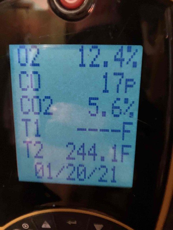 Responded to service call for 29-year-old furnace with exhaust fan squealing. Diagnostic testing revealed combustion readings of 12.4% O2, 17ppm CO, 5.6% CO2, and stack temperature of 244.1°F, indicating inefficient operation. Inspected fan assembly and found worn gear component with visible corrosion. Provided customer with multiple replacement options due to unit's advanced age.