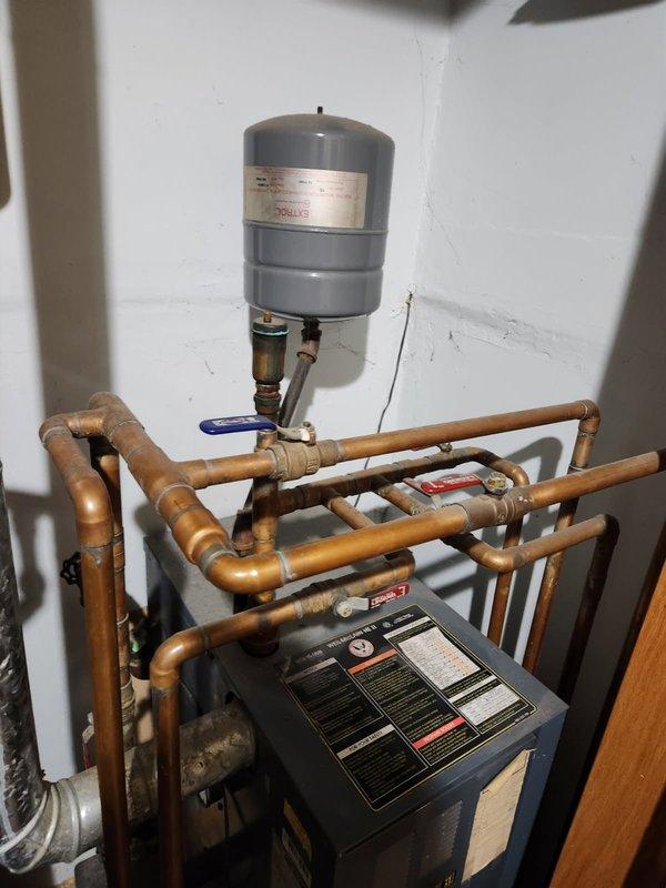 Responded to no heat complaint on 34-year-old Weil McLain boiler. Diagnosed hydro locking issue and sporadic aquastat operation. Observed significant corrosion on valve components and aging expansion tank requiring replacement. Completed necessary repairs to restore heating function.