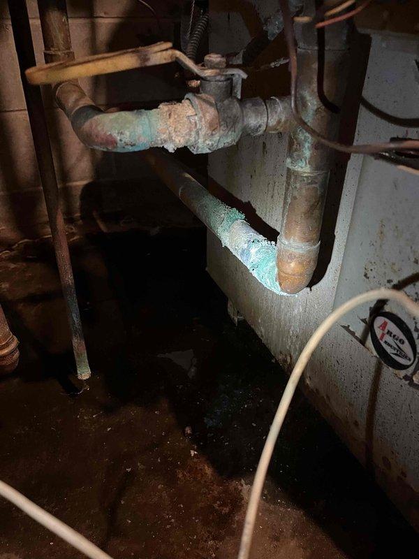 Responded to no heat complaint at multi-unit residence with 1980s boiler system. Identified and resolved heating issue by bleeding air from upper level register and replacing failed expansion tank with ruptured bladder. Documented significant pipe corrosion throughout system, particularly at valve connections, and provided customer with replacement system options via email.
