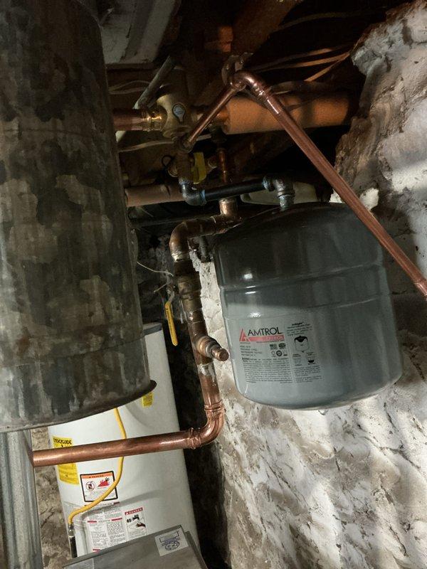 Completed repiping work to establish proper air separation within the hydronic system. Replaced failed components including drain valve, expansion tank, relief valve, and inducer motor capacitor, while installing new drain and purge valves for improved maintenance access. Retained functional autofeed/backflow preventer to maintain system integrity and pressure regulation.
