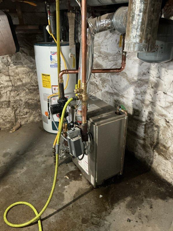 Completed repiping work to establish proper air separation within the hydronic system. Replaced failed components including drain valve, expansion tank, relief valve, and inducer motor capacitor, while installing new drain and purge valves for improved maintenance access. Retained functional autofeed/backflow preventer to maintain system integrity and pressure regulation.