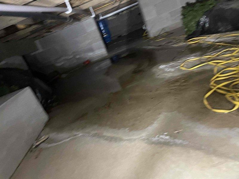 Responded to no heat call for 13-year-old boiler system. Discovered frozen zone pipe for main level with evidence of water damage to surrounding wooden structure. Inspected basement area showing moisture issues, with standing water visible on concrete floor. Waiting for system to thaw before proceeding with final repair.