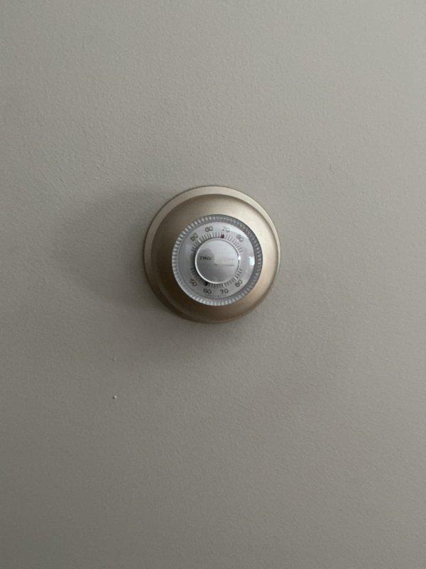 Responded to service callback for non-functioning basement thermostat after previous service. Inspected both the analog circular thermostat and digital Honeywell thermostat in the home. Identified zone board communication issue causing basement thermostat failure. Rescheduled appointment with technician specialized in zone board systems for proper diagnosis and repair.