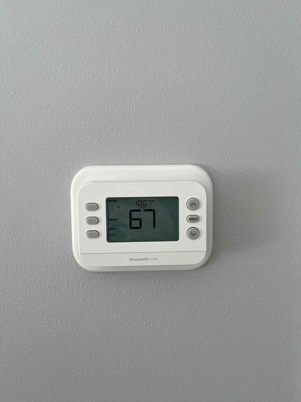 Completed installation of four thermostats per customer approval, including one Wi-Fi enabled Honeywell Home model (set to 78.7°F with current reading of 67°F) and three non-programmable thermostats. Verified proper operation of all units with one digital display showing current temperature of 68°F and time of 10:08.