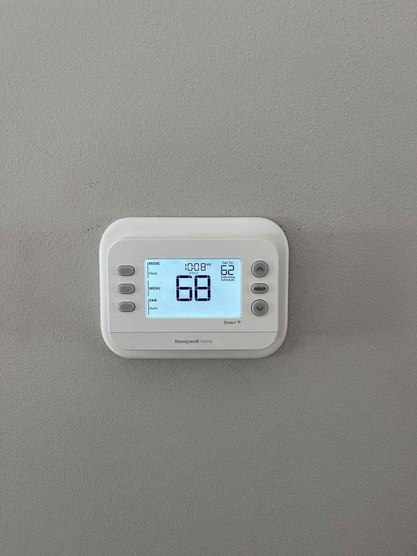 Completed installation of four thermostats per customer approval, including one Wi-Fi enabled Honeywell Home model (set to 78.7°F with current reading of 67°F) and three non-programmable thermostats. Verified proper operation of all units with one digital display showing current temperature of 68°F and time of 10:08.