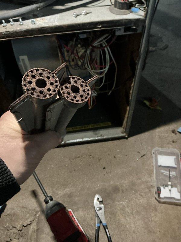 Performed preventative maintenance on two 8-year-old furnaces that were not maintaining adequate heating capacity. Removed and inspected circular perforated components, likely filters or burner assemblies. Both units are operational but require regular maintenance to improve performance and efficiency.