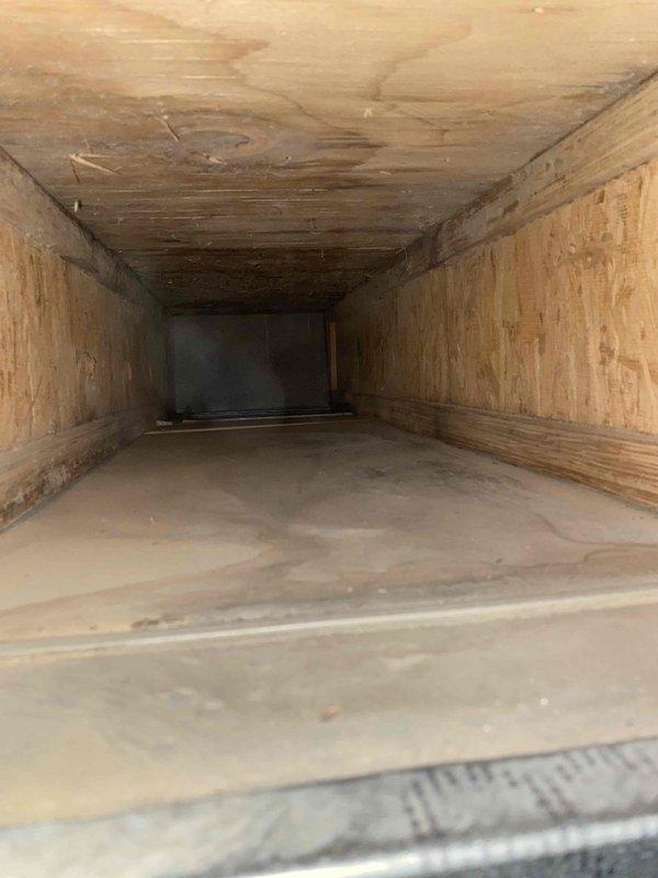 Completed duct cleaning service addressing significant dust accumulation and debris in the trunk lines and return duct. Inspection revealed wooden duct surfaces with visible water damage and discoloration on the upper surfaces. Thoroughly cleaned all accessible trunk lines, removing built-up dust and contaminants to improve system efficiency and air quality.