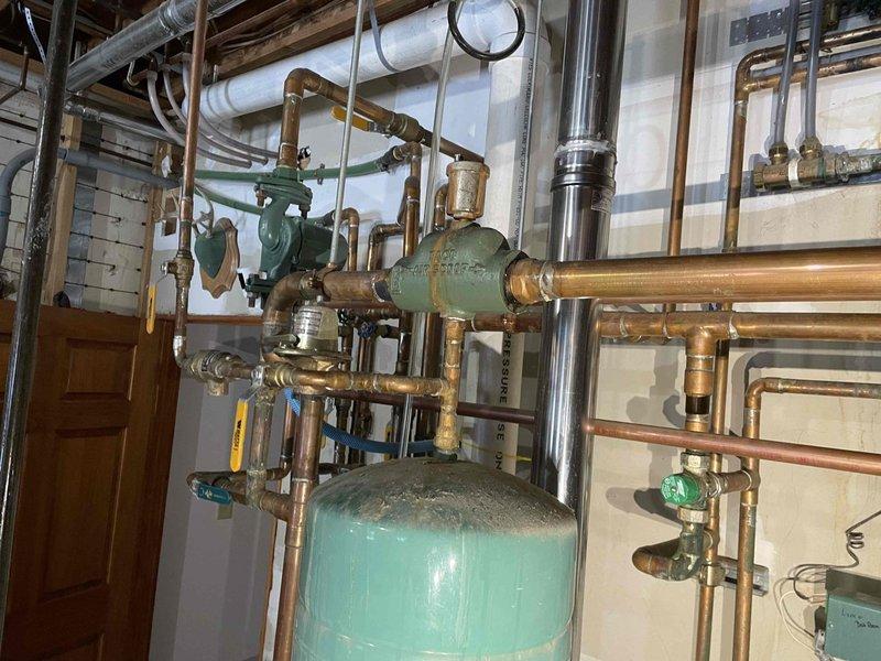 Responded to emergency no-heat call for boiler failure. Diagnosed multiple issues including failed furnace inducer, suspected leaking heat exchanger, and significant corrosion throughout copper piping system. Restored system pressure and performed necessary repairs/replacements to restore heating function before customer's weekend guests with small children arrive.