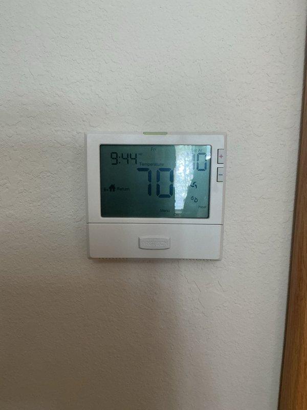 Diagnosed thermostat issue where system would only heat to 67°F due to incorrect schedule settings. Adjusted programmable thermostat schedule according to homeowner's preferences, restoring proper temperature control functionality. Verified system operation with temperature now reading 70°F on the digital display.