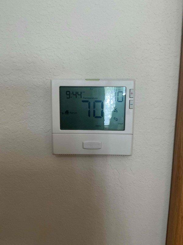 Diagnosed thermostat issue where system would only heat to 67°F due to incorrect schedule settings. Adjusted programmable thermostat schedule according to homeowner's preferences, restoring proper temperature control functionality. Verified system operation with temperature now reading 70°F on the digital display.