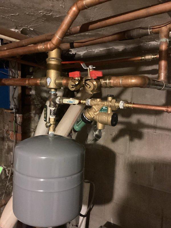 Completed replacement of both pumps in the heating system as per Mitch K's approved estimate. System was flushed with cleaner and appropriate level of antifreeze was added. Installation included proper connection of electrical wiring to the new pump assemblies and verification of all copper pipe connections and brass valves for proper operation.