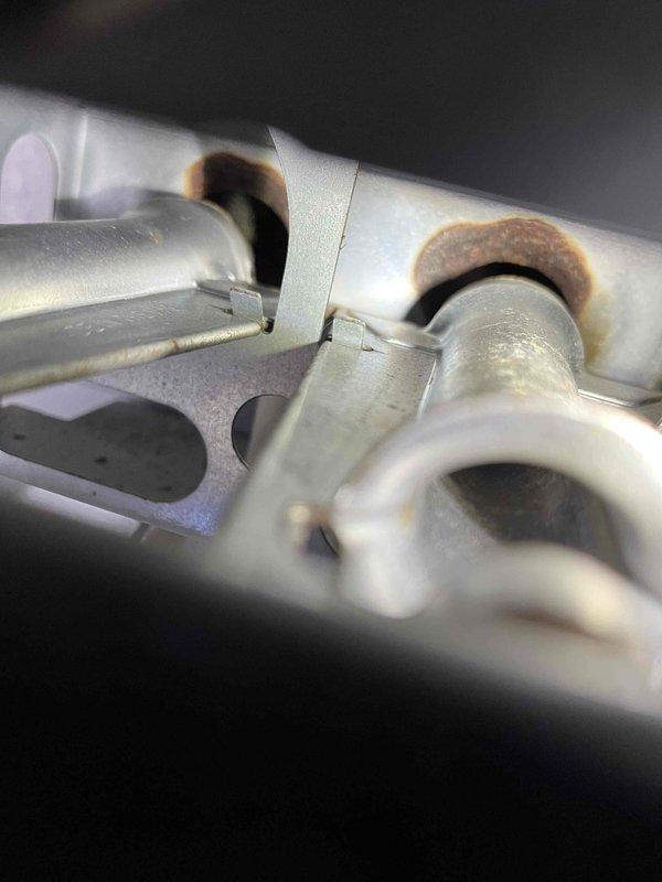 Performed annual prepaid maintenance inspection on furnace under partner plan. Identified several issues including flame sensor with dead spot and high resistance, significant burner corrosion visible on heat exchanger assembly, and accumulated dirt on blower wheel. Presented customer with repair options to address these concerns.