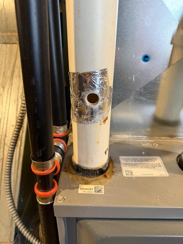 Responded to customer concern regarding exposed exhaust pipe on Armstrong Air furnace. Upon inspection, found PVC exhaust pipe with unsealed hole allowing potential exhaust gas infiltration into home. Properly sealed the hole using RTV sealant and installed blue plug to ensure safe system operation and prevent carbon monoxide hazard.