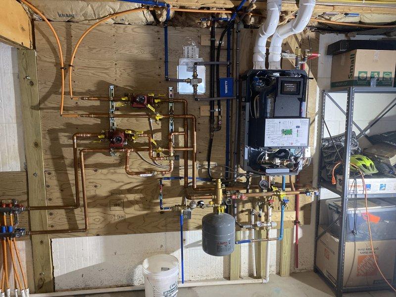 Successfully installed mixing valve as requested per Caden's estimate. The installation was integrated with the existing copper plumbing network featuring multiple shutoff valves. System now properly configured with all connections secure and operational.