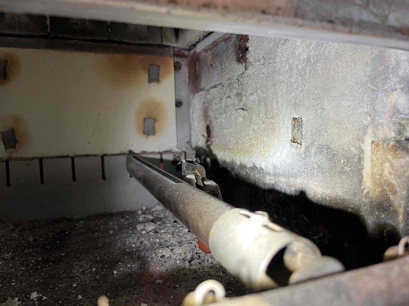 Performed inspection on an aged Slant Fin boiler reported to be making noise, finding CO leakage from deteriorated heat exchanger and degraded antifreeze in system. Observed significant moisture damage and possible mold growth on surrounding infrastructure. Advised customer that heat exchanger replacement would be difficult/costly as manufacturer is out of business and recommended system cleaning, flush with new antifreeze, and potential replacement of original zone pumps and valves.