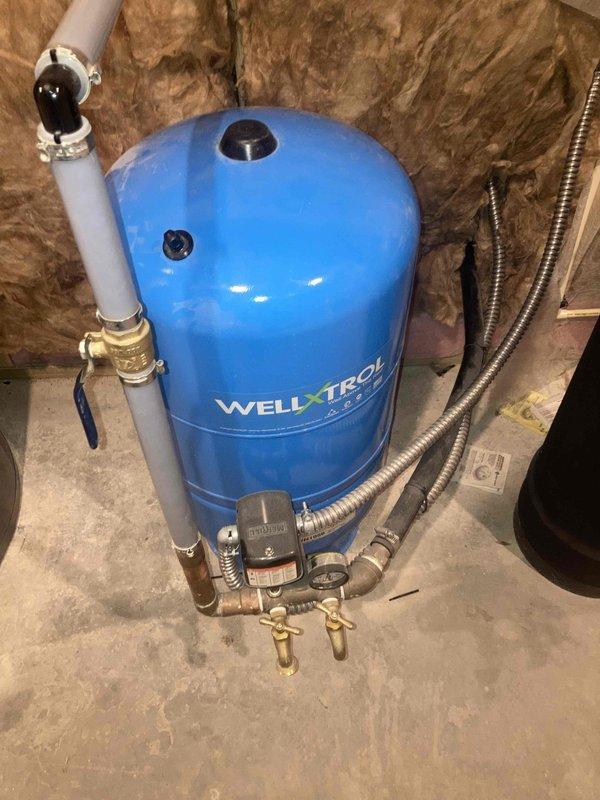 Completed annual prepaid preventative maintenance on residential water treatment system, including inspection of water heater, blue WELL-X-TROL pressure tank, and water filtration components. Verified proper operation of water softener unit with digital control panel and confirmed all connections, valves, and pressure readings were within normal operating parameters.