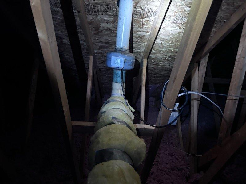 Inspected attic ventilation system and identified significant damage to PVC vent pipe joint with visible cracking, separation, and failed sealant. Documented moisture intrusion and potential mold accumulation at connection point where vent fan is leaking. Unable to complete repair during initial visit due to insufficient ladder height; scheduled return visit with appropriate extension ladder to access roof and complete necessary repairs.