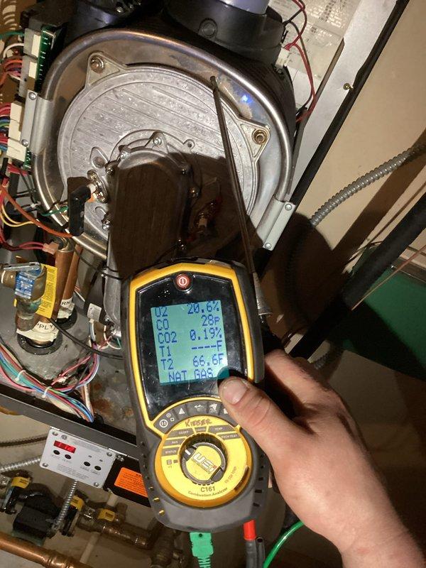 Diagnosed FLU error code on aging boiler system with heat exchanger leaking water and carbon monoxide, confirmed with combustion analyzer readings showing unsafe CO levels. Cleared plugged condensate drain line but determined unit has catastrophic failure requiring replacement due to compromised heat exchanger integrity. Advised customer of safety concerns and replacement options.