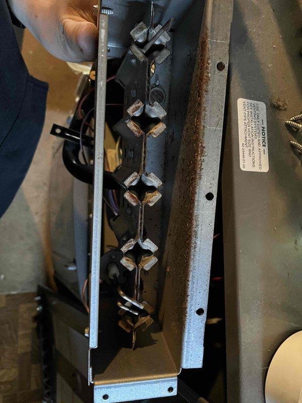 Performed annual inspection on rental property furnace, observing notable corrosion on burner assembly, flame sensor, and igniter. Documented evidence of deterioration with significant rust formation around burner ports and mounting brackets. Completed evaluation of system components and provided customer with estimates for recommended repairs.