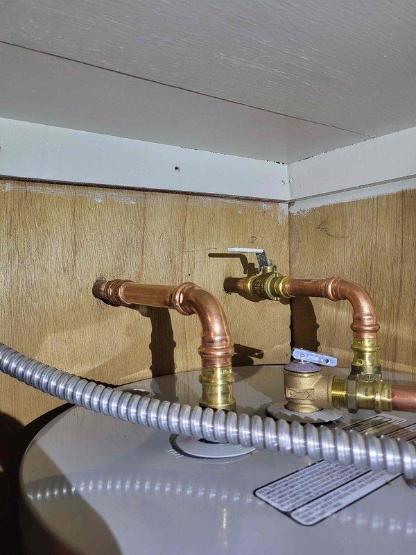 Successfully installed new 30-gallon water heater with proper copper pipe connections and shutoff valves. Repaired damaged water line that was causing water supply interruption. Completed installation of customer-supplied fixtures including sink faucets in kitchen and bathroom, showerhead, and new toilet as requested.