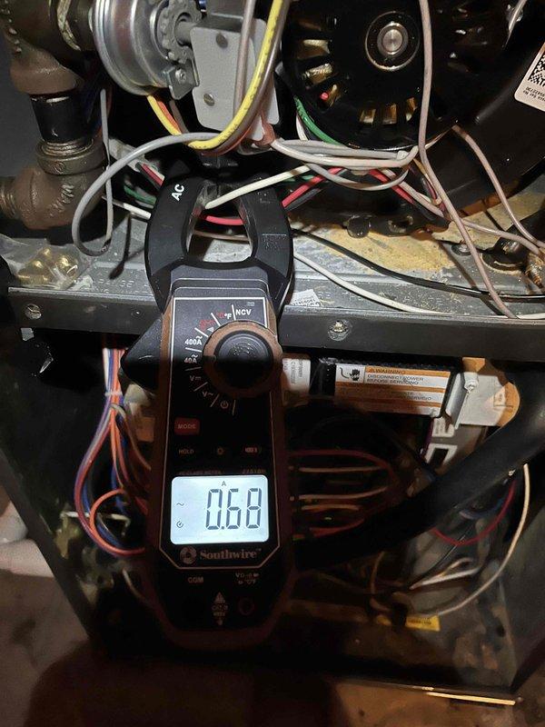 Diagnosed Amana furnace shutdown issue with internal temperature at 59°F. Inspection revealed multiple ignition failures on the control board history, with flame sensor exhibiting a dead spot and soot accumulation on burners. Replaced flame sensor and performed thorough burner cleaning, then verified system operation through multiple successful ignition cycles.