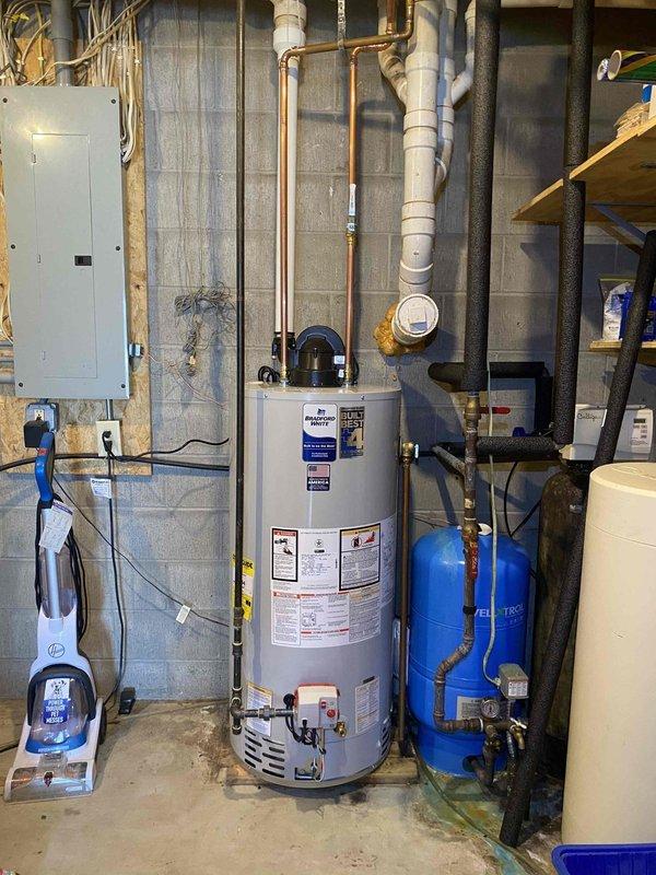 Successfully removed existing 50-gallon power vent water heater and installed new Bradford White 50-gallon short power vent LP water heater. Repositioned water and gas lines as needed while reusing existing vent termination and majority of 3" venting. Completed all necessary connections and verified proper operation of the new ICON System control unit.