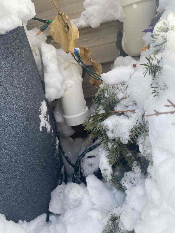 Responded to no-heat call for Lennox furnace. Diagnosed flame ignition failure causing system to blow cold air with indoor temperature at 63°F. Discovered snow-covered intake pipe was plugged; cleared obstruction to restore proper combustion air flow and normal heating operation.