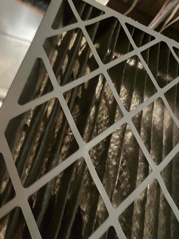 Responded to no-heat call for Lennox furnace. Diagnosed flame ignition failure causing system to blow cold air with indoor temperature at 63°F. Discovered snow-covered intake pipe was plugged; cleared obstruction to restore proper combustion air flow and normal heating operation.