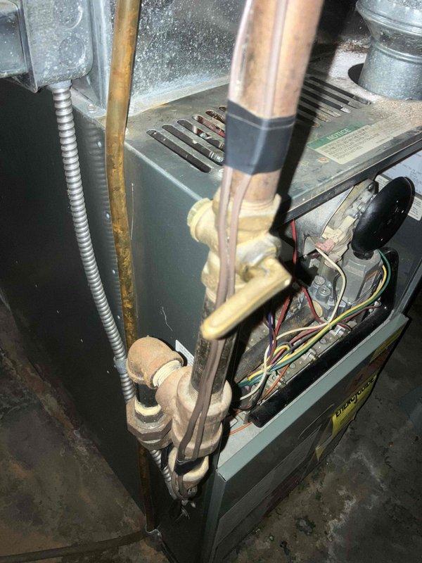 Responded to no heat call for 18-20 year old Rheem furnace blowing cold air. Diagnostic inspection revealed cracked heat exchanger, which presents safety hazard and explains cold air output. Recommended immediate replacement of unit due to age and condition of critical components.