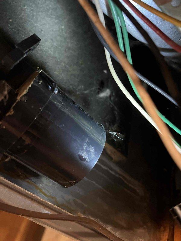 Responded to service call for furnace leaking water in basement. Identified leak at junction of condensate trap and PVC drain piping. Repaired by cementing trap to drain PVC and securing condensate lines from flue and collector box with proper crimping. Visual inspection confirmed proper repair of condensate drainage system.