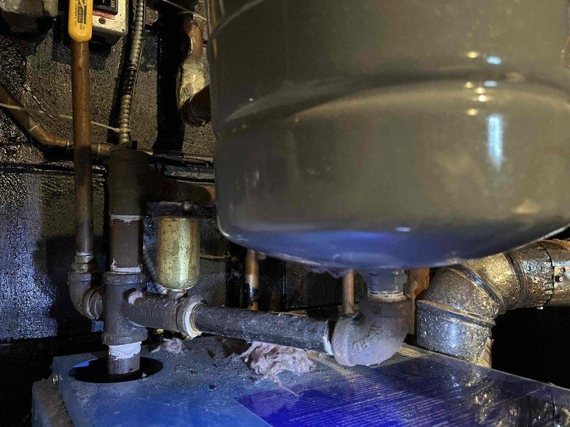 Performed annual inspection on boiler system, identifying ruptured bladder in expansion tank and age-related wear on multiple components. Documented condition with photographs showing plumbing installation details and interior compartment deterioration, then provided customer with repair options via email.
