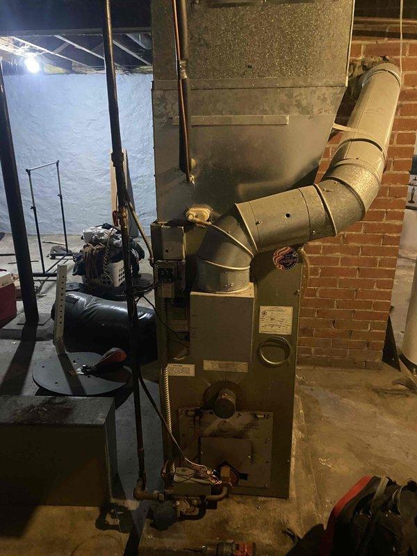 Diagnosed and replaced failed blower motor in aging furnace that was smoking and non-operational. Extensive dust buildup was found throughout the system, particularly on the blower assembly, indicating lack of regular maintenance. System was thoroughly cleaned and tested for proper operation after motor replacement.