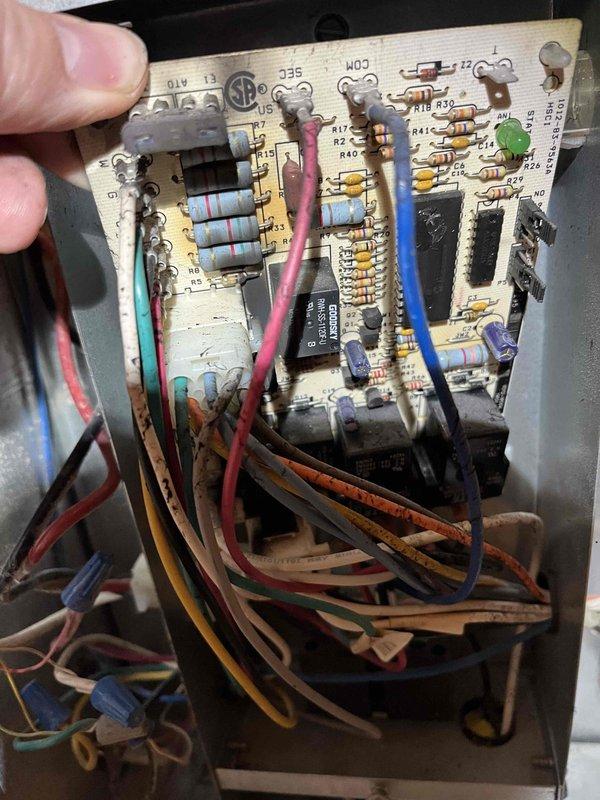 # Service Report: No Heat Call - Furnace Control Board Failure

Responded to no heat call on furnace system over 10 years old. Upon arrival and initial inspection, discovered significant heat damage to the main control board and associated components. Visual examination revealed melted areas on the circuit board with multiple electronic components showing thermal stress and discoloration. 

Performed diagnostic assessment and documented the extent of damage through photographic evidence, capturing both the component side and solder side of the control board to show heat-affected areas, damaged traces, and compromised electronic components including resistors, capacitors, and integrated circuits. The control board exhibited clear signs of electrical failure with visible burn marks and deteriorated connections.

Presented repair options to customer including component replacement and system evaluation. Customer elected to proceed with comfort advisor consultation for comprehensive system