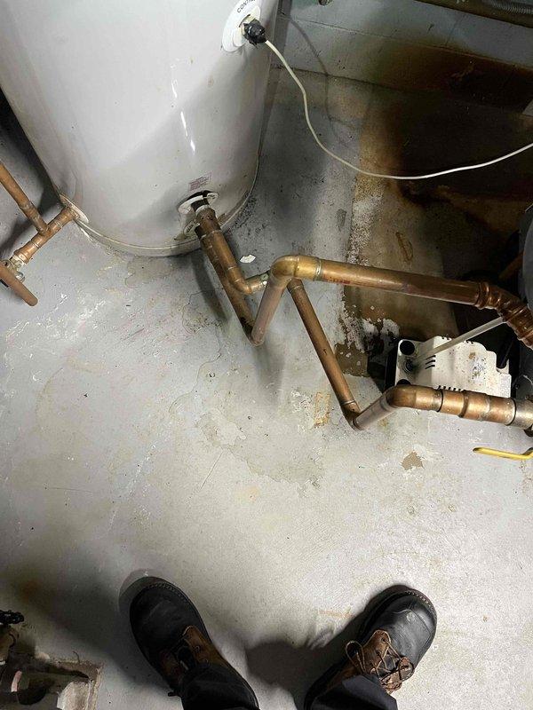 Completed annual prepaid maintenance inspection on boiler system. During inspection, identified active leak on condensate discharge line. Repaired leak by replacing damaged section of discharge line using customer-provided hose and barbed fitting to restore proper condensate drainage and prevent water damage.