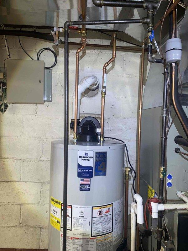 Replaced failed 50-gallon natural gas water heater due to leaking tank. Installed new Bradford White 50-gallon natural gas power-vent water heater with proper venting, copper supply line connections, pressure relief valve, and all required safety components per manufacturer specifications and local code requirements.